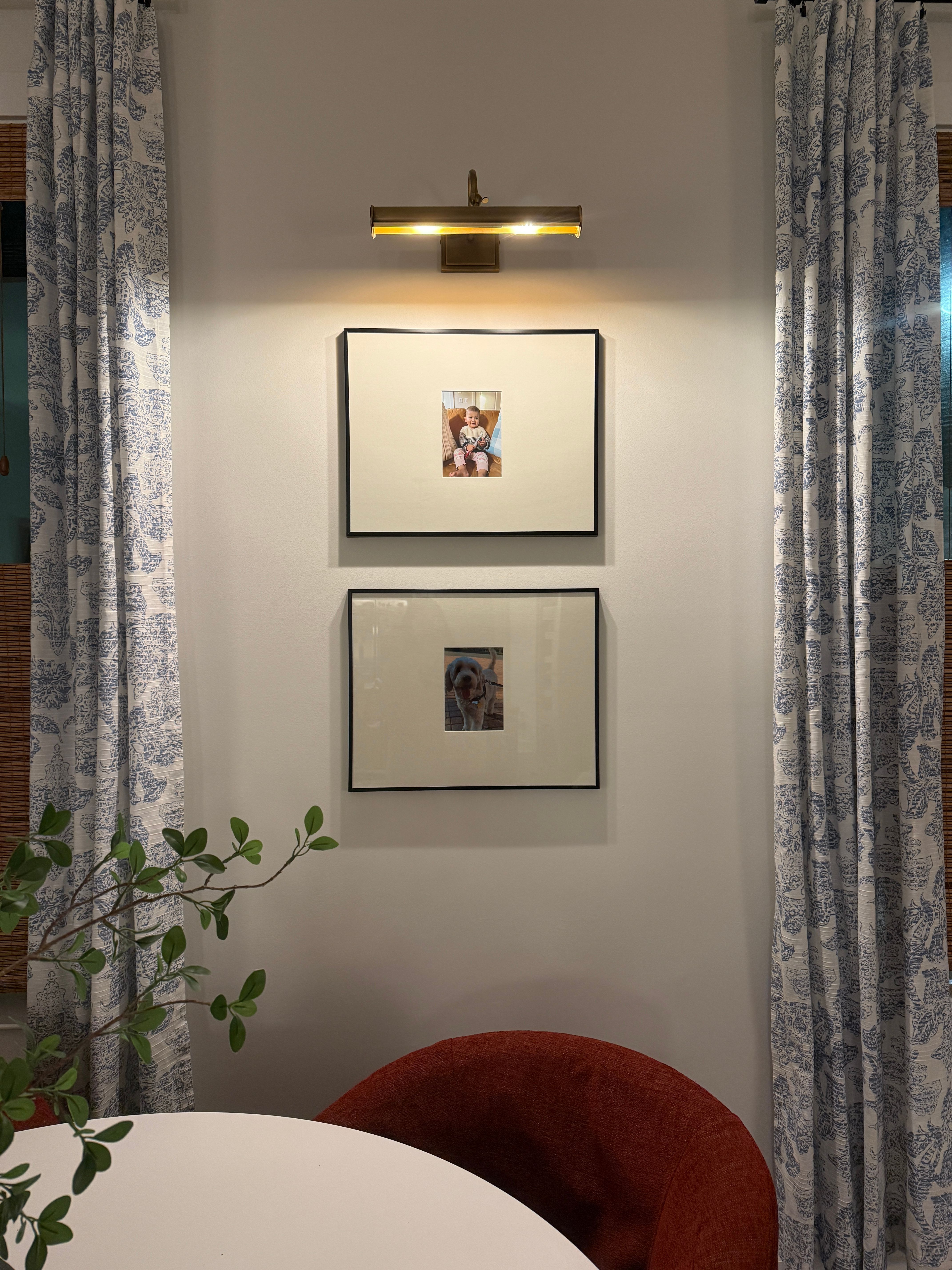 Simple gallery wall with picture light styled by Pragya Saikia Design in Herndon, Virginia